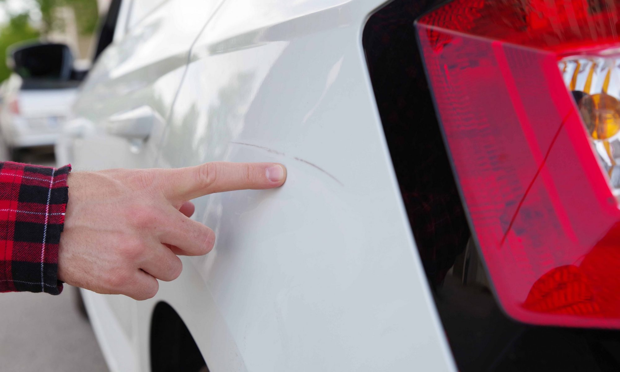 showing light scratch on a white car