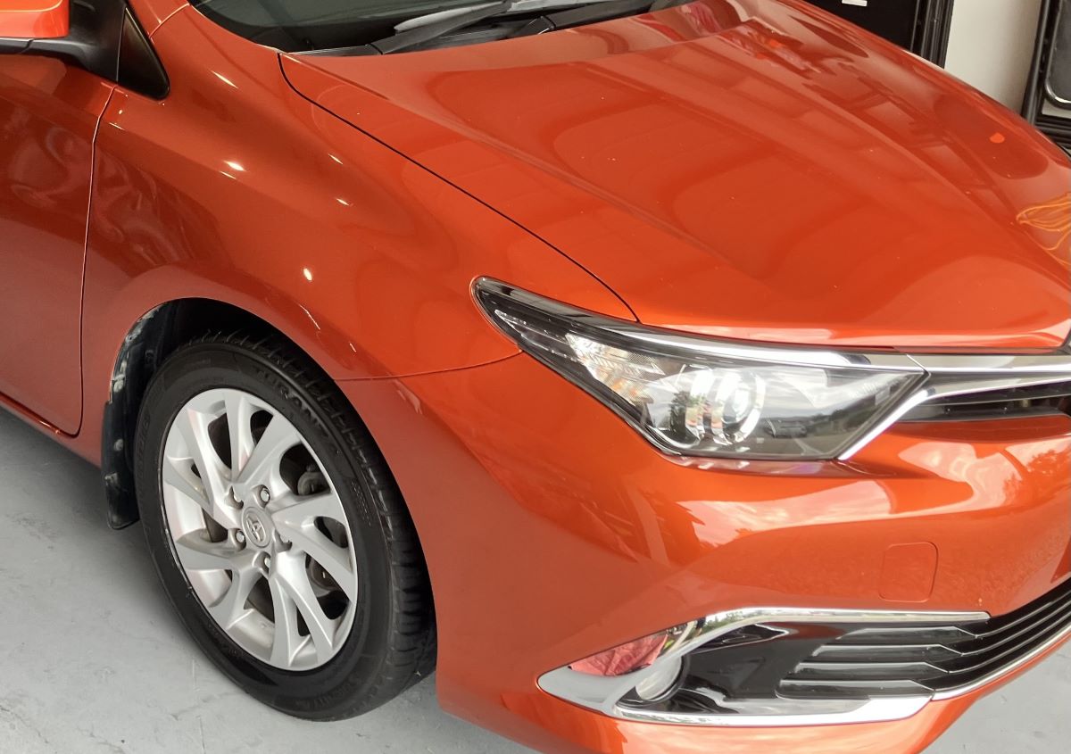 “Freshly polished burnt orange Toyota Corolla with a high-gloss finish on the Gold Coast.”