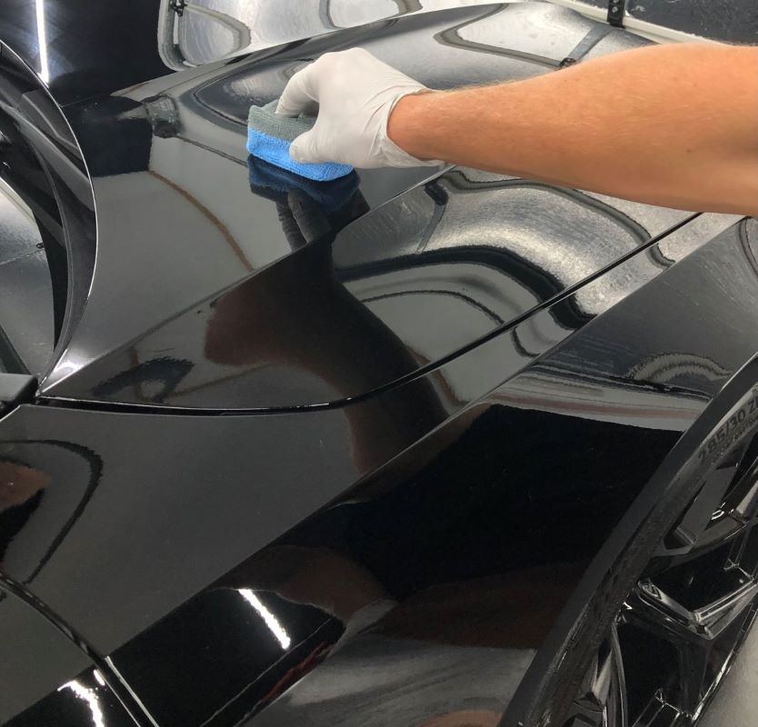 Technician applying ceramic coating to a car on the Gold Coast