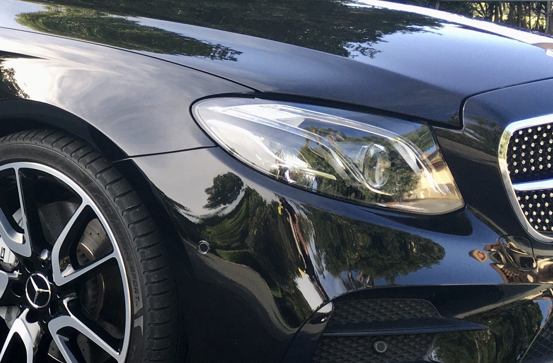 "Close-up of a car’s vibrant paint after polishing."