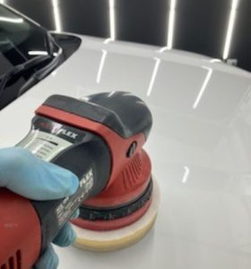 "Car undergoing professional paint correction."